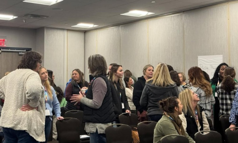 Michigan School Counselor Association Conference attendees networking and talking in a breakout room after a session.