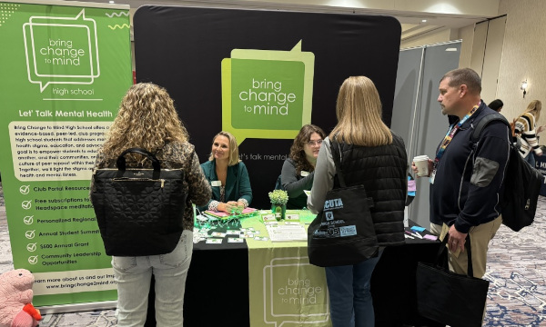 Bring Change to Mind exhibitor booth with attendees.