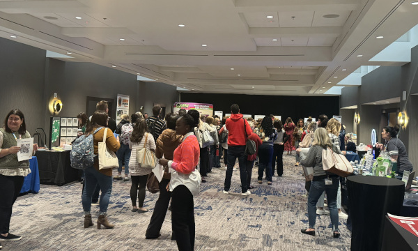 Attendees walking through the conference exhibit hall.