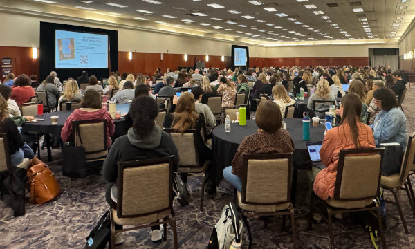 Conference attendees listening to a presentation.