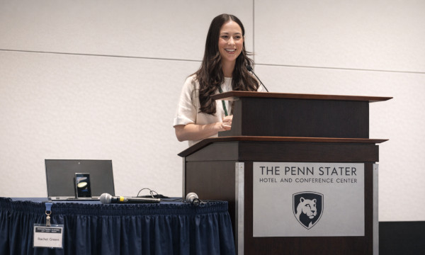 Speaker presenting at a conference podium