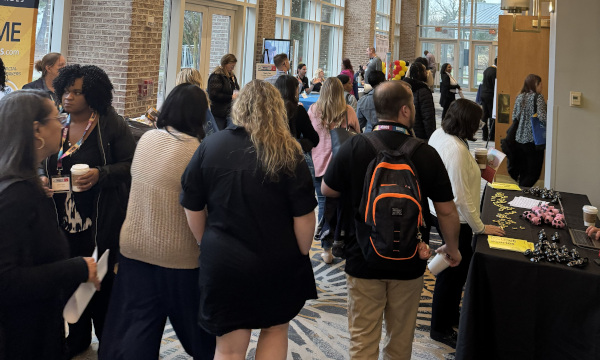 Exhibitor hall full of people and tables