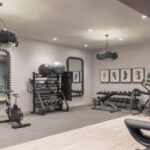 A fitness room inside of a hotel, with cardio equipment and free weights