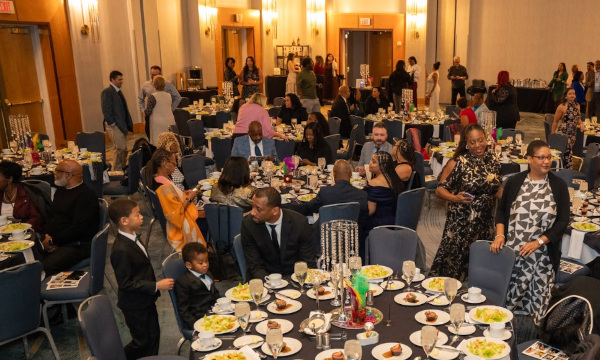 Crowd of people at a luncheon with round tables