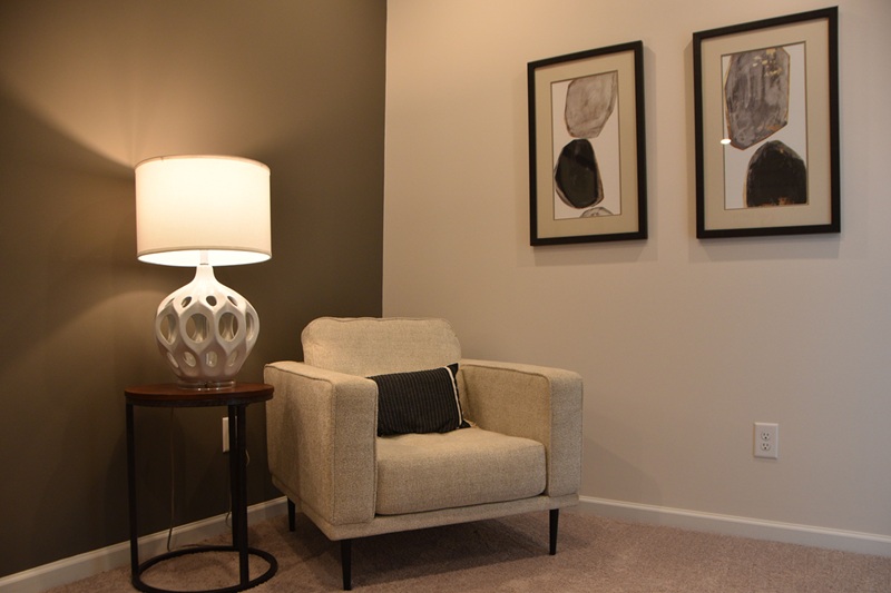 Comfortable chair with a small table and lamp next to it