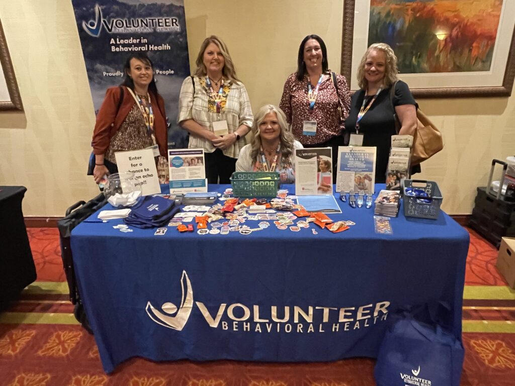 Exhibitors welcoming attendees at their booth during the Southeast School Counselor and Administrator Leadership Institute.